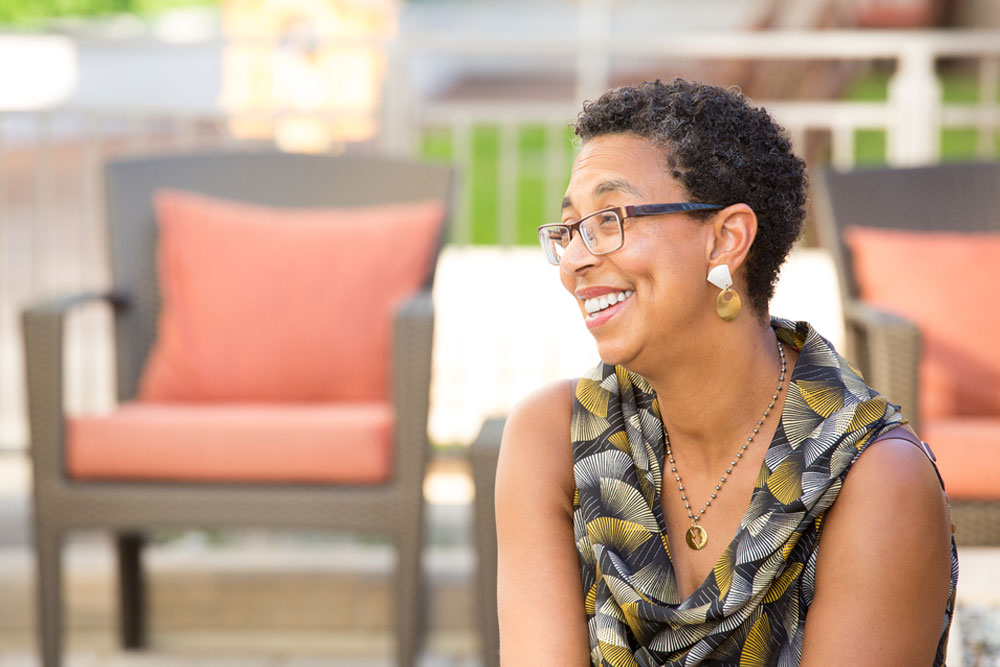 mature woman with glasses sitting and smiling