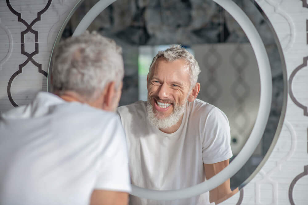 Man smiling in mirror