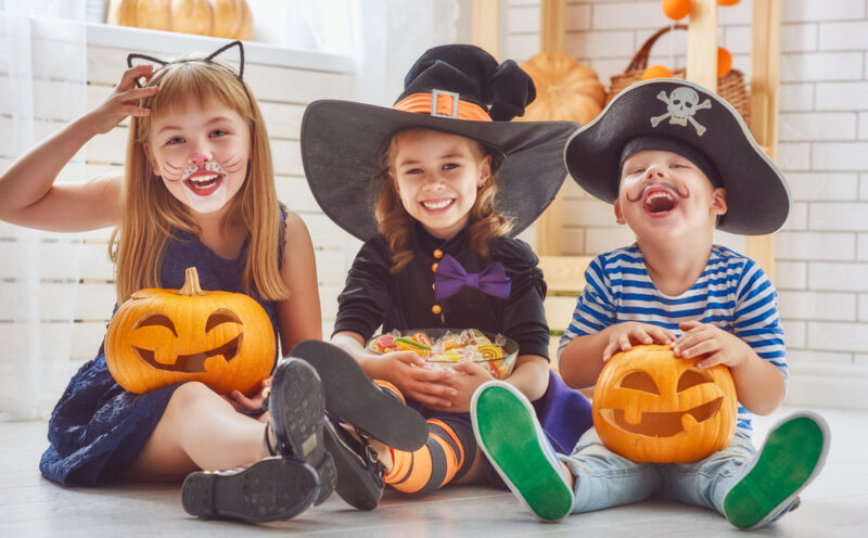Kids in Halloween costumes smiling