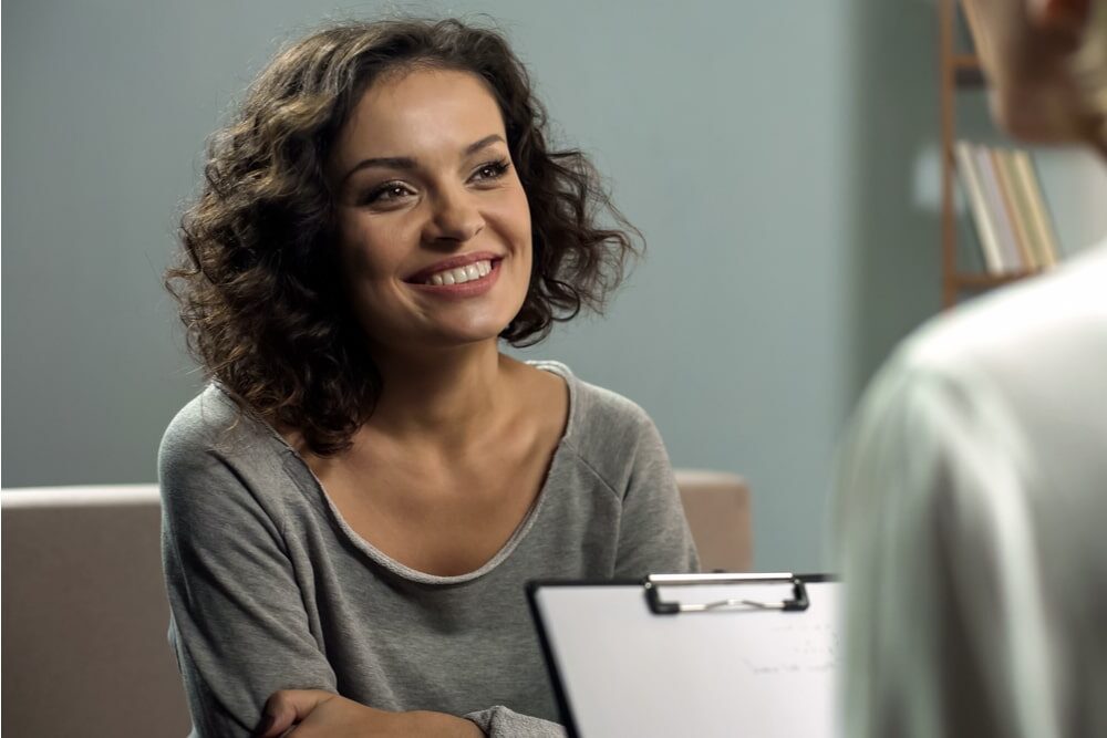 Young smiling lady at rehab therapy session,
