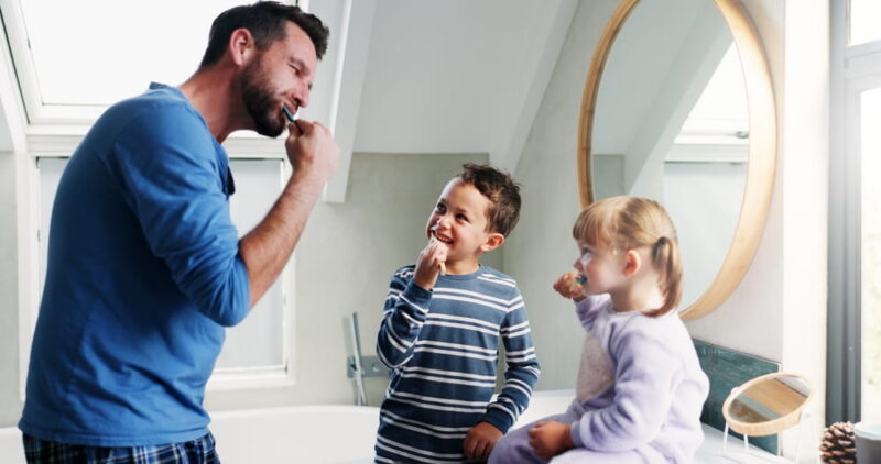 Blogs 3 used to demonstrate the concept of Blogs Father, bathroom and brushing teeth with children in home for morning routine, dental hygiene and oral health
