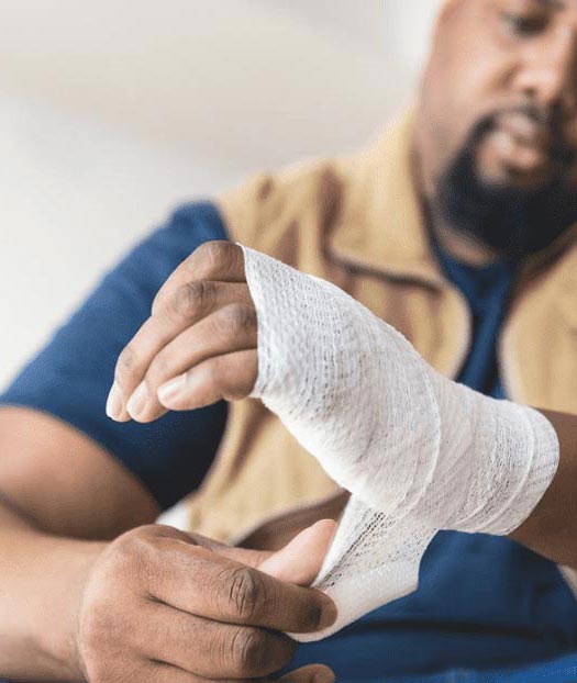 A man wrapping his hand after Hand Surgery