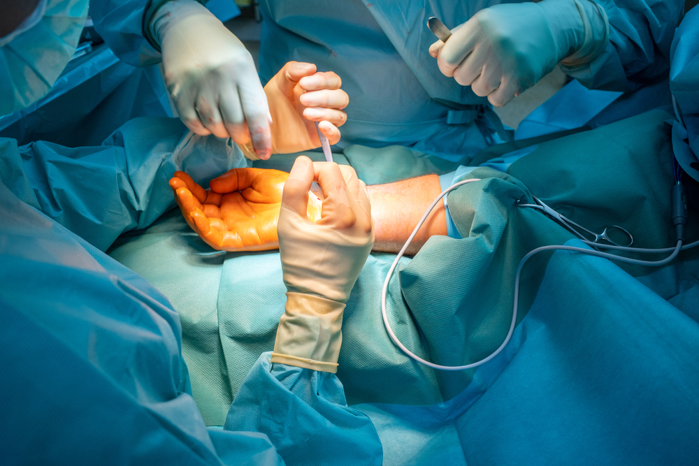 two doctors operate on a wrist fracture in an operating theatre
