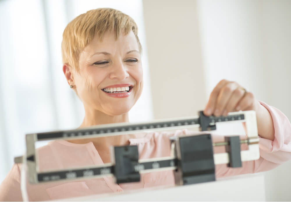 Woman adjusting sliding weight scale