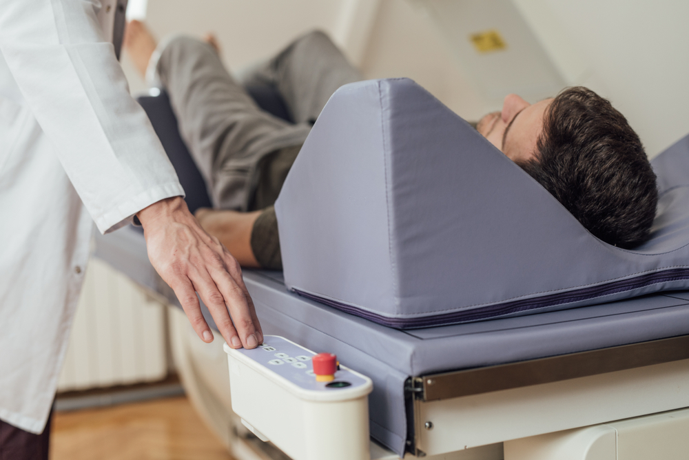 A patient lying down for a DEXA Scan to measure bone density