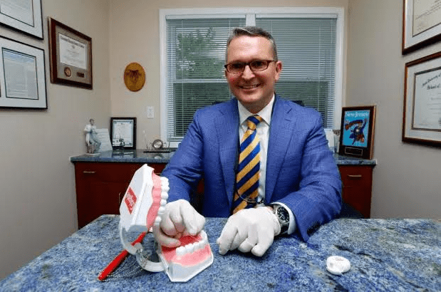 Doctor flossing on model