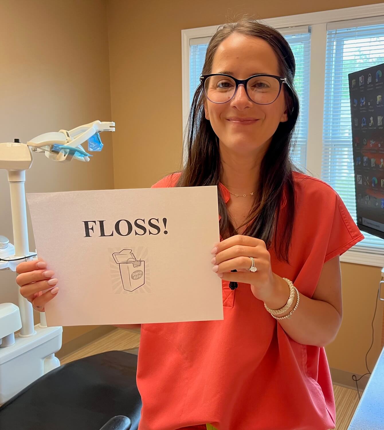 dental hygienist holding floss sign