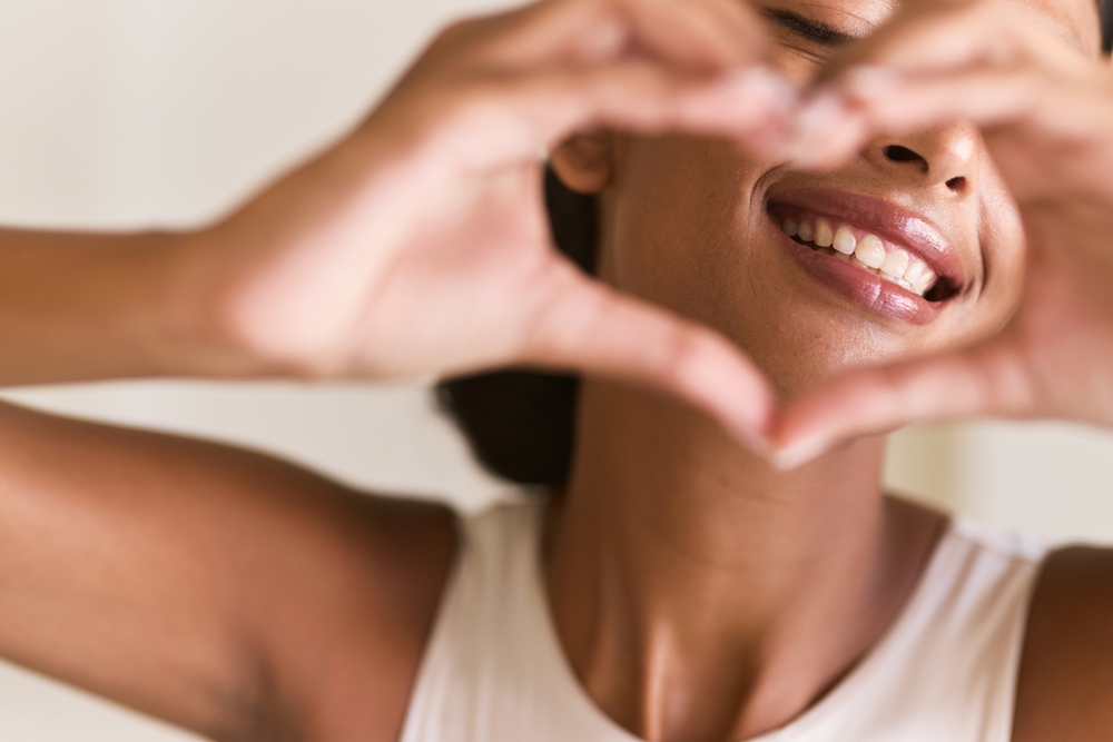 Dental Care Smile. Woman Making a Heart Shape with Her Hands
