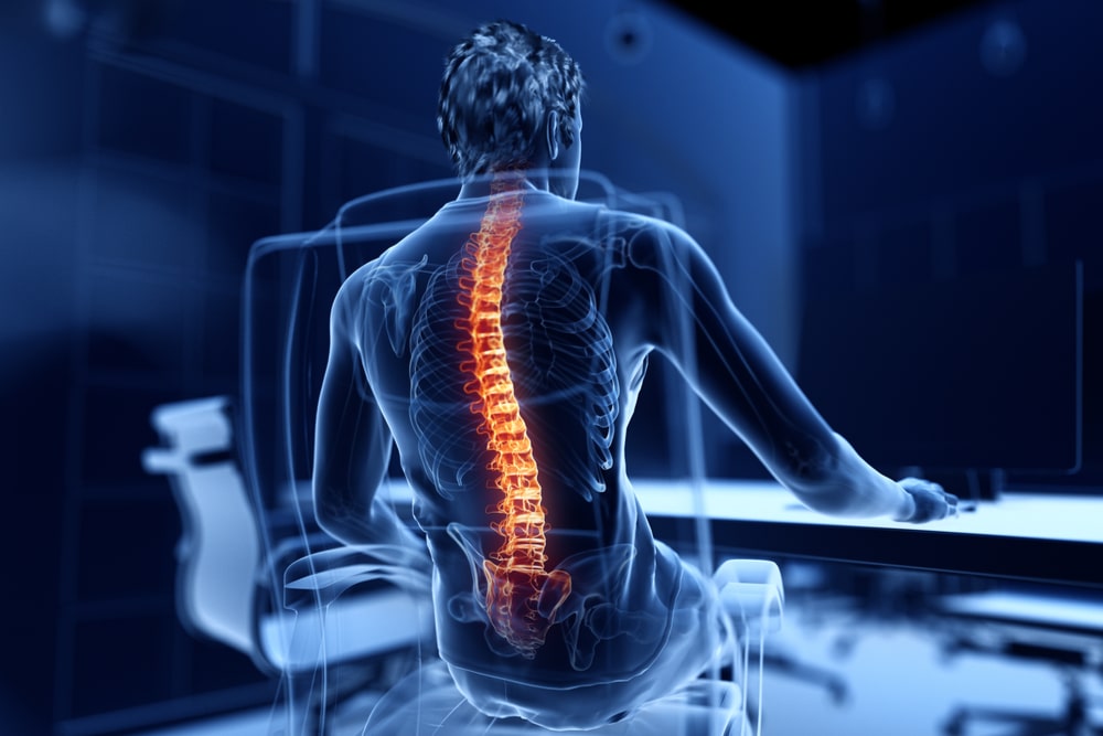 3d rendered illustration of a man working on a pc - having a painful back