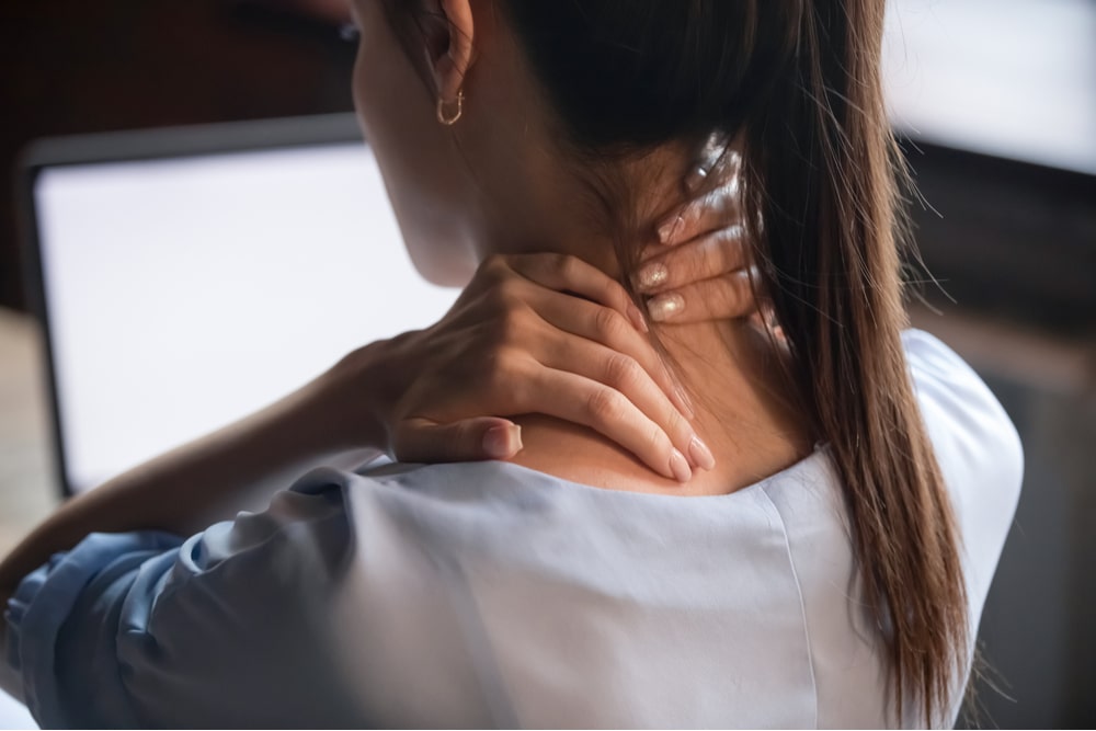 Tired woman massaging rubbing stiff sore neck tensed muscles fatigued