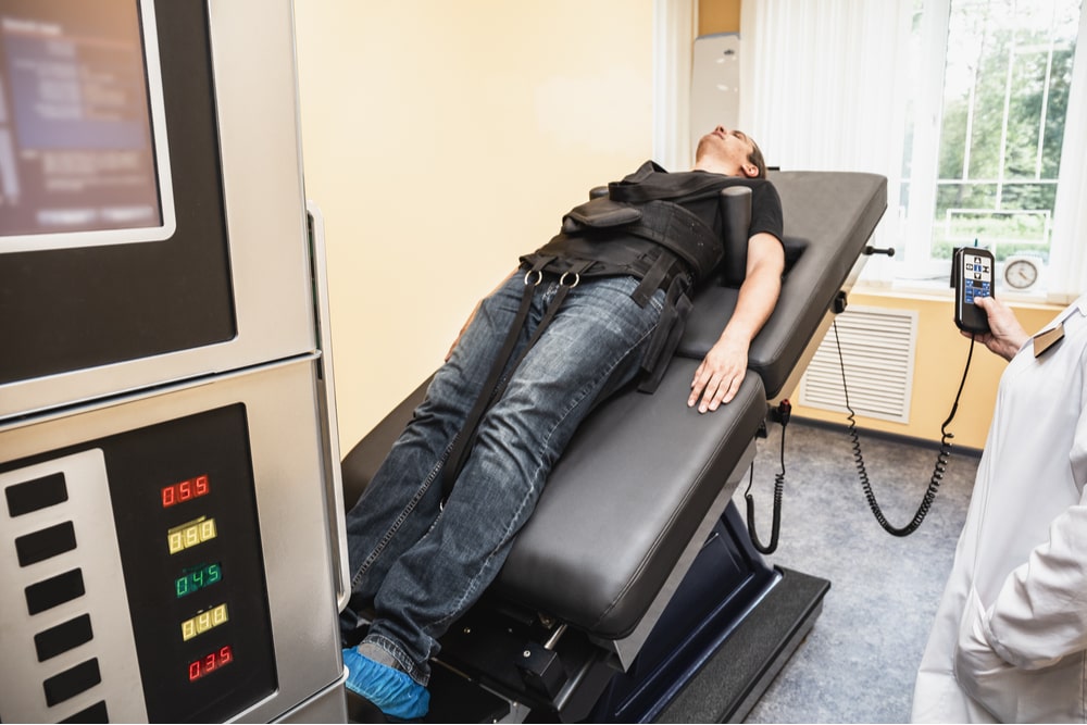 Man with problems of low back spinal hernia on stretching and decompression procedure