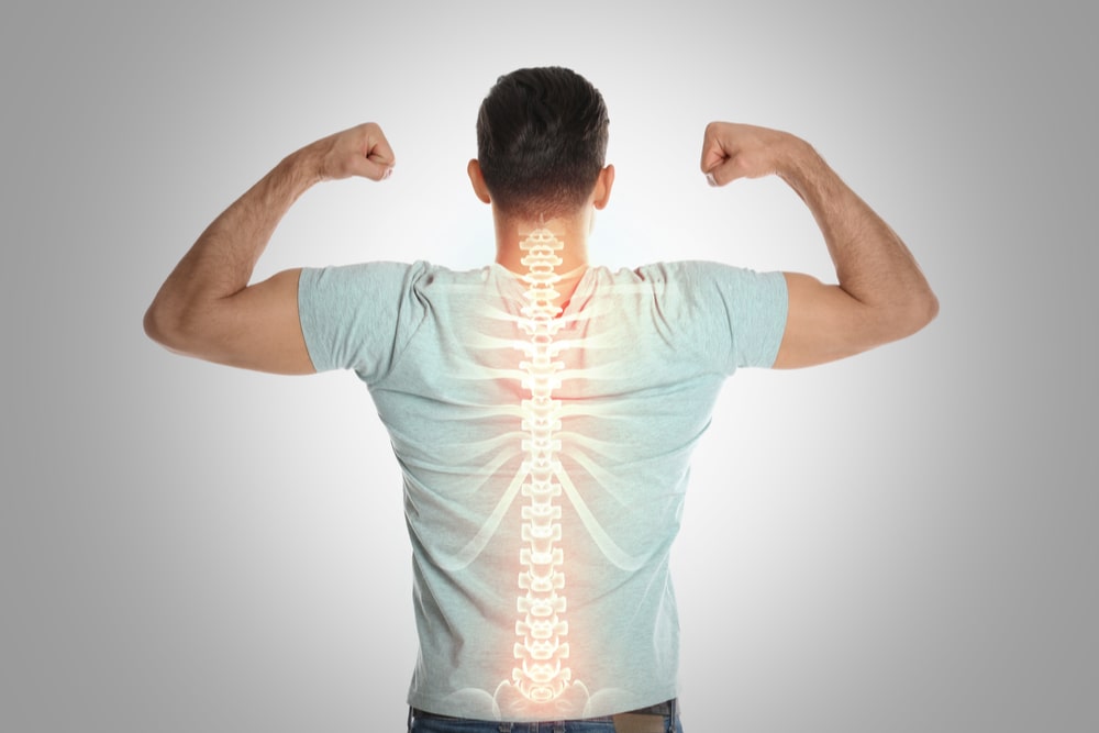 Man with healthy back on light background. Spine pain prevention