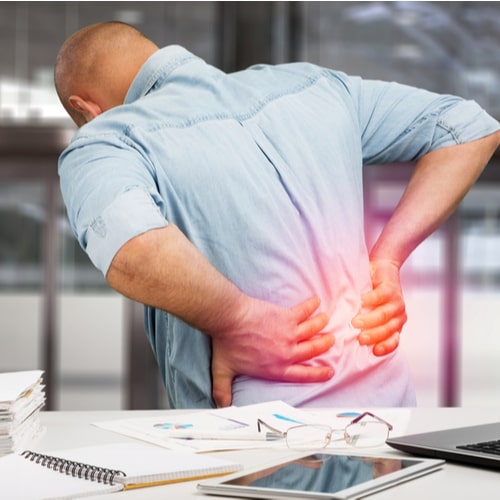 Business man with back pain in office