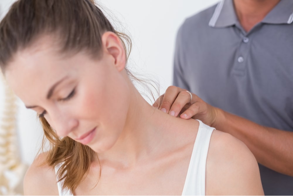 Doctor doing neck adjustment in medical office