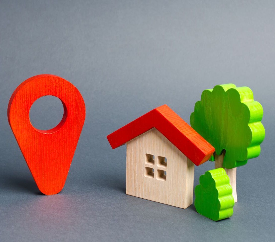 Toy blocks creating a house, tree, and location icon
